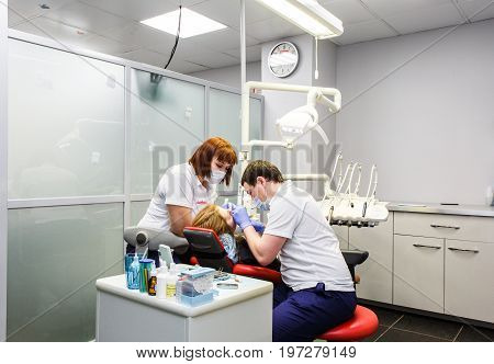 Moscow, Russia. June 2017 The dentist and the assistant work on the patient in the clinic