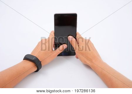 Fitness Bracelet And Phone In Female Hands On White