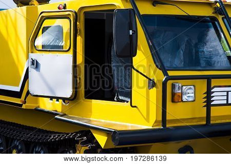 yellow buldozer in a construction site with open cabine