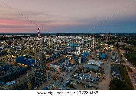 Aerial view of the petrochemical oil refinery plant shines at night