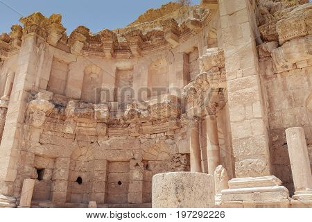 The ancient Roman city in Jerach Jordan Nymphaeum summer time blue sky background.