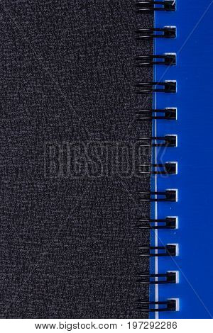 Blue notepad on a spiral on a black background