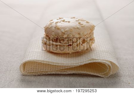 Delicious macaroon vanilla flavor presented on a well folded fabric.