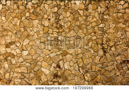 part of a stone wall, brownish beige tones for background or texture