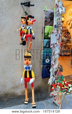 Street Souvenir Shop With Wooden Pinocchio Puppets In Siena