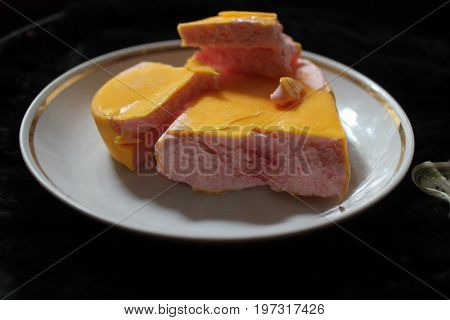 sweet  ice-cream from fruit covered yellow glaze lay on plate for  dessert time