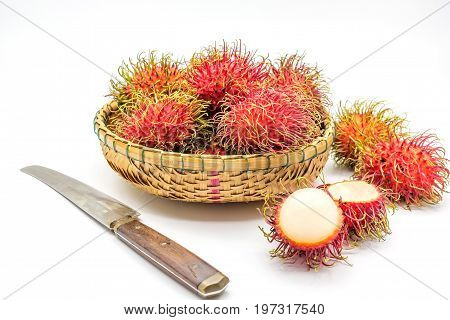 fresh tropical rambutan fruits over basket with knife on a white background fruit in Thailand