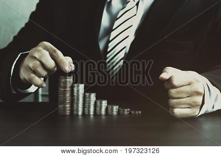 hand of businessman staced on money coins in vintage style