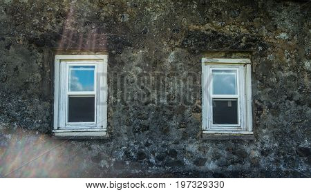 A view of windows of the old church at Keanae Point on Maui Hawaii.