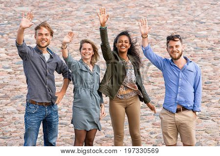 Group Of Young Friends Waving Their Hands
