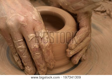 Women Hands In Process Of Making Clay Bowl On Pottery Wheel