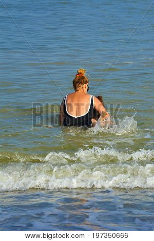 Grandmother and granddaughter bathe in the open sea. July 2017 Odessa Ukraine.