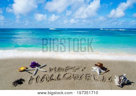Halloween background with starfishes on the sandy beach near the ocean