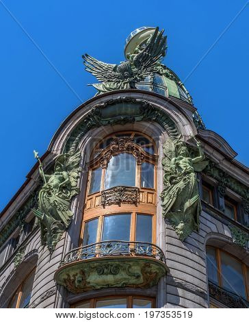The balcony of the upper floor of the house-singer-. The balcony is richly decorated with sculptures and relief decorations. The glass dome above the balcony is crowned by a glass globe.