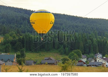Schodnica Ukraine - July 07 2014: Yellow balloon in Carpatian hills