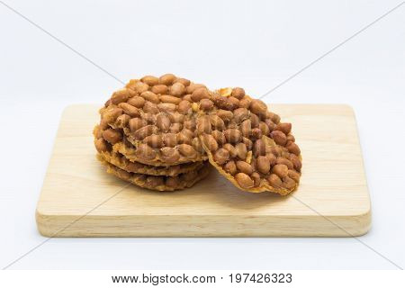 Sweet peanut deep fried on wooden board on white background