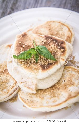 Pancakes with apples decorated with mint and brown sugar