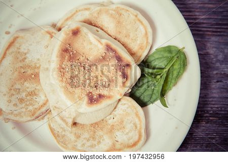 Pancakes with apples decorated with mint and brown sugar
