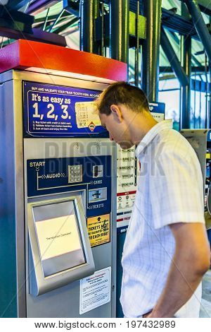 Burke, Usa - April 16, 2017: Young Man Buying Tickets In Machine At Burke Centre Train Station Platf