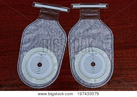 Two white cellophane receptacles on a red surface