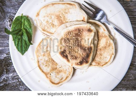 Pancakes With Apples Decorated With Mint And Brown Sugar