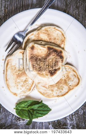 Pancakes With Apples Decorated With Mint And Brown Sugar