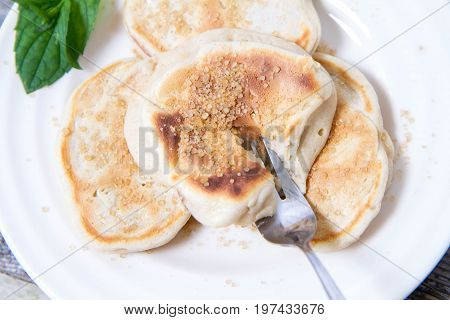 Pancakes With Apples Decorated With Mint And Brown Sugar
