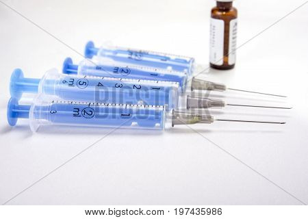 Four injections with needles on the white background