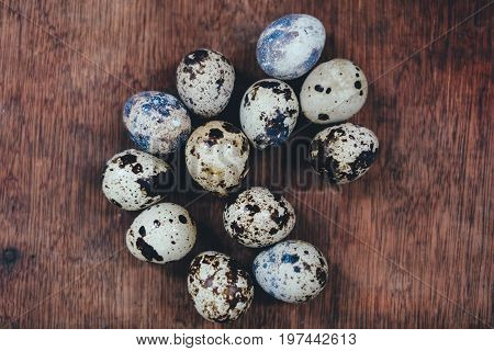 many quail eggs. quail eggs on the brown table. quail eggs on wooden background