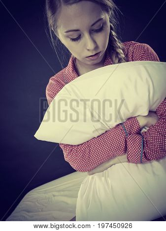 Sad Depressed Girl In Bed Gripping Pillow