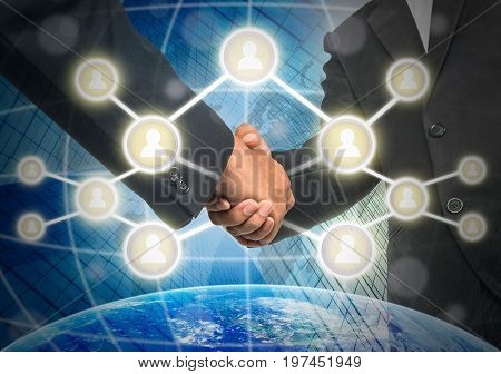 Business handshake with Social media symbol over the building and world map background Elements of this image furnished by NASA Business social netwok concept