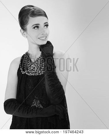 beautiful young woman in retro style with her hair in little black dress