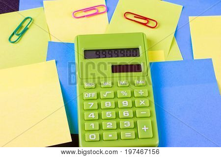 Multi colored pasted stickers and green calculator