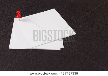 white sticker attached drawing pin on the black background