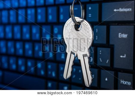 Metal key on the keyboard background. The concept of encryption.