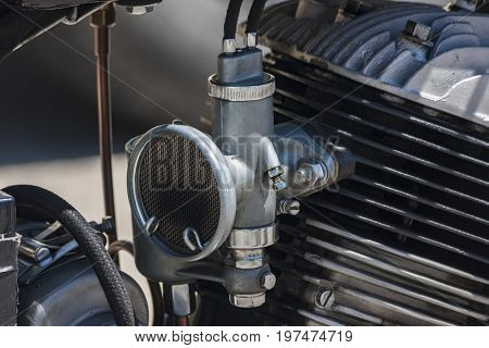 Old antique motor and its carburettor at the engine