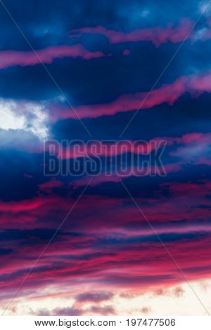 mysterious fiery sky with altocumulus clouds at sunset