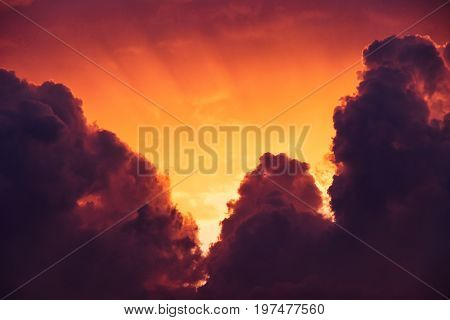 moody, smoky and golden sky with cumulonimbus clouds at sunset - W for weather