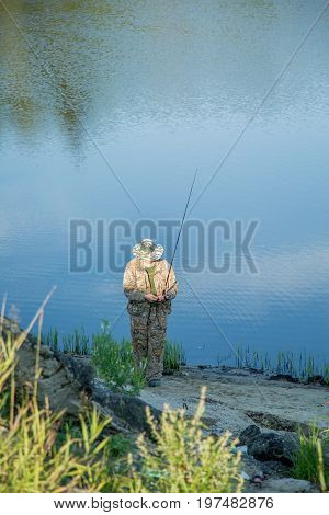 The fisherman catches a pike for spinning off the bank of the channel
