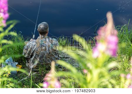 The fisherman catches a pike for spinning off the bank of the channel