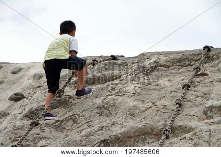 Japanese Boy Climbing On The Wall (second Grade At Elementary School)