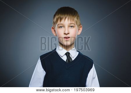 Closeup Portrait of happy boy going surprise isolated on gray background.