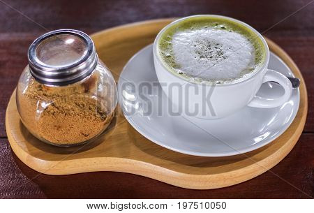 Hot matcha green tea latte glass with milk