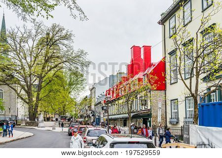 Quebec City Canada - May 29 2017: Old town Sainte Anne street with restaurants by place d'arms park by Chateau Frontenac with people walking