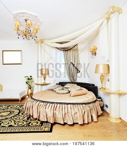 Cassical golden bedroom interior with round bed