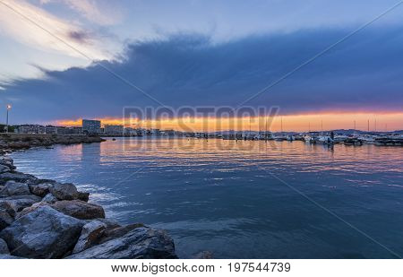 Sunset or blue hour in quiet port of l'Escala, Costa Brava, Spain. Mediterranean Sea