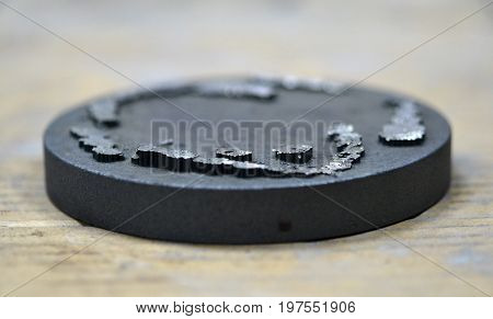 The working disk of the laser unit for melting the metal and the remains of the model printed on it