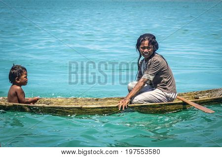 Semporna,Sabah,Malaysia-Apr 23,2017:Sea Gypsy kids on unique handmade boats surrounded by beautiful clear water of the Bodgaya island,Semporna,Sabah,Malaysia
