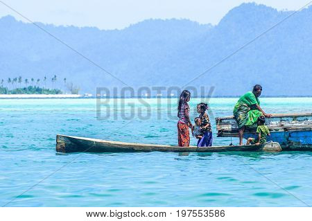 Semporna,Sabah,Malaysia-Apr 23,2017:Sea Gypsy kids on unique handmade boats surrounded by beautiful clear water of the Bodgaya island,Semporna,Sabah,Malaysia