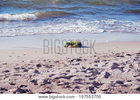A wreath washed up on a Baltic sea coast - Midsummer